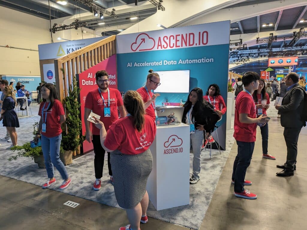 Ascend's booth at Snowflake Summit 2024 full of people discussing data automation and AI.